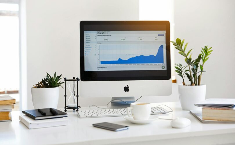 silver imac displaying line graph placed on desk